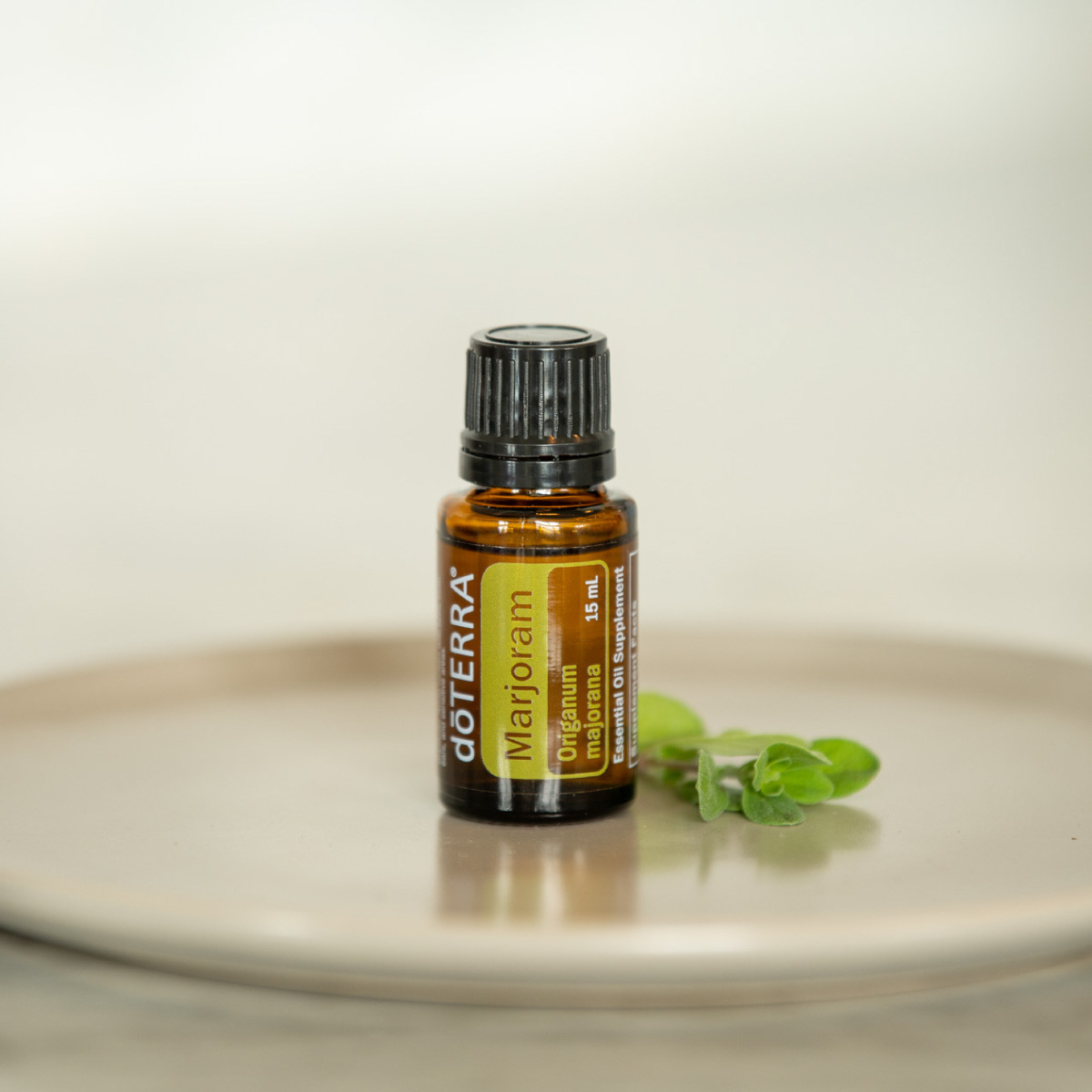 Bottle of Marjoram essential oil on a plate with fresh marjoram leaves, next to a fork and knife. How do I use marjoram essential oil? You can use Marjoram oil for cooking in place of dry marjoram. 